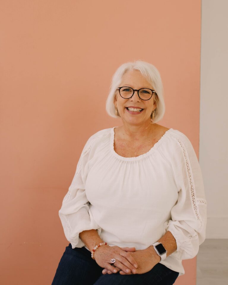 Gail next to a pink background